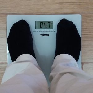 person stepping onto weight scale